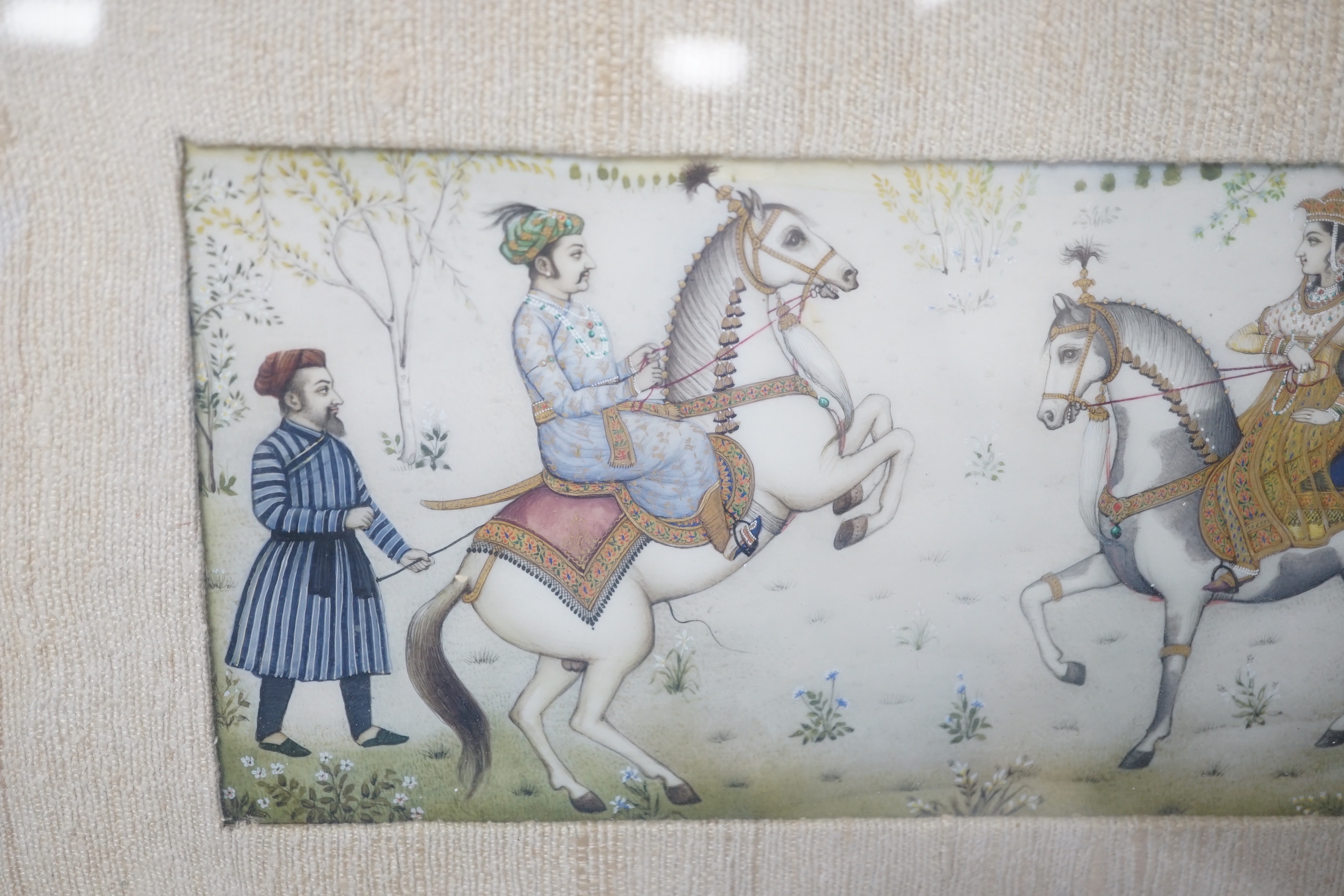 Indian Mughal style miniature on ivorine, 20th century depicting Shah Jehan - Mumtaz Ali on horseback, glazed frame, 20cm wide x 10cm high